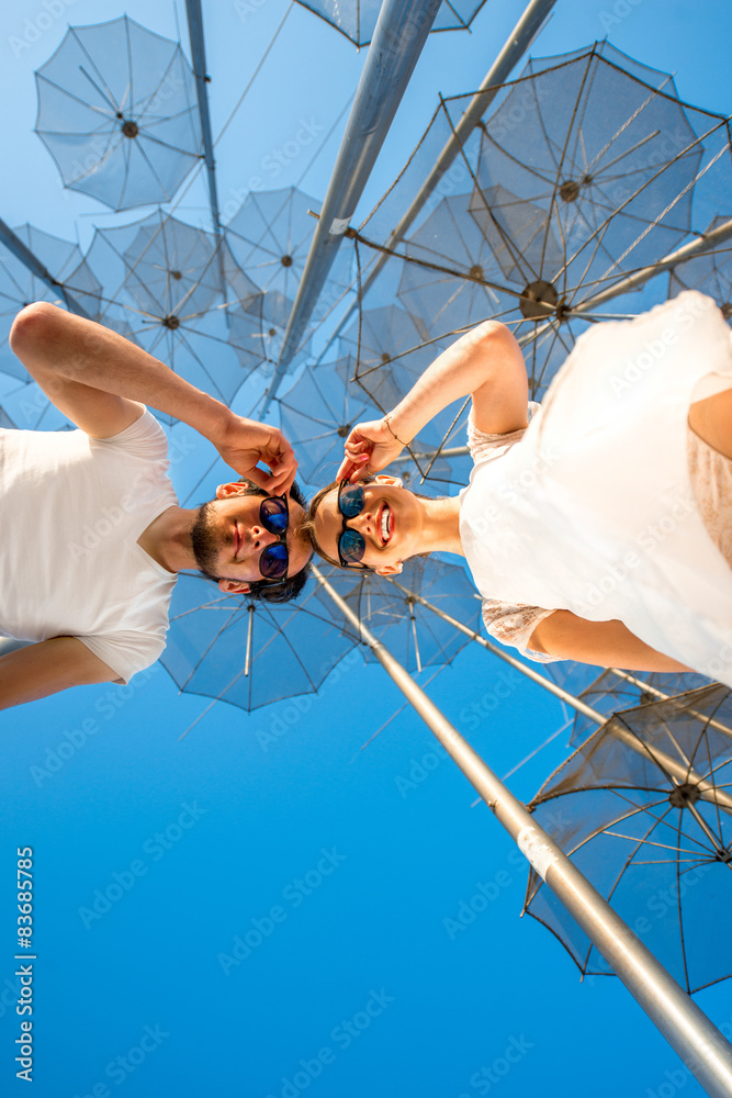 Portrait of Couple on the abstract background with umbrellas