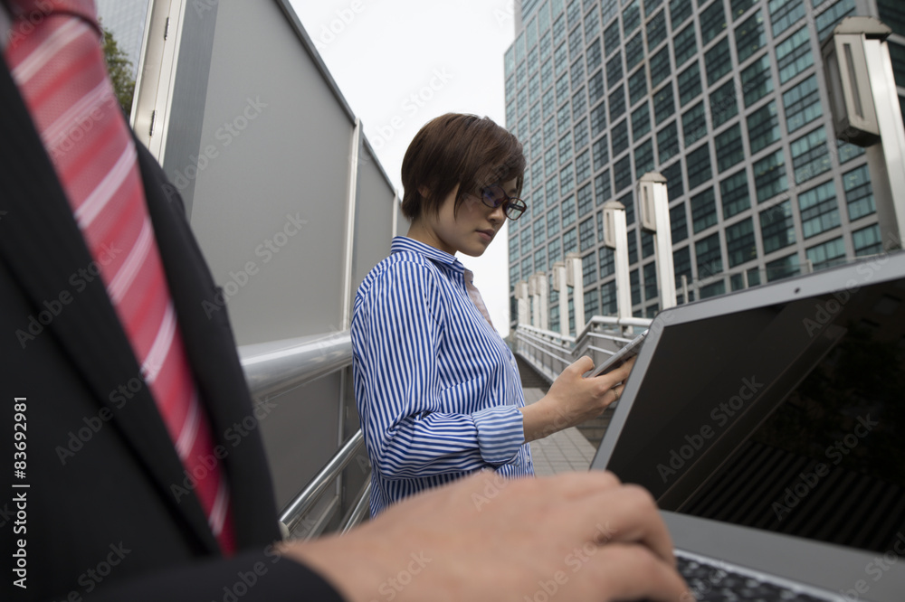 Businessmen are using a laptop in the office district