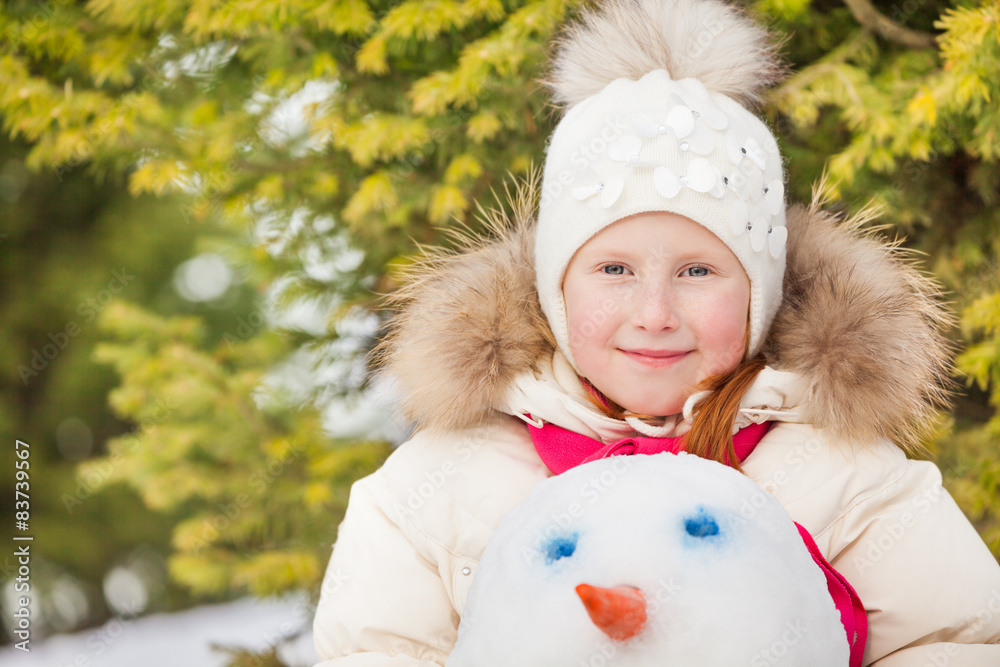 Portrait of girl who is holding snowmans head