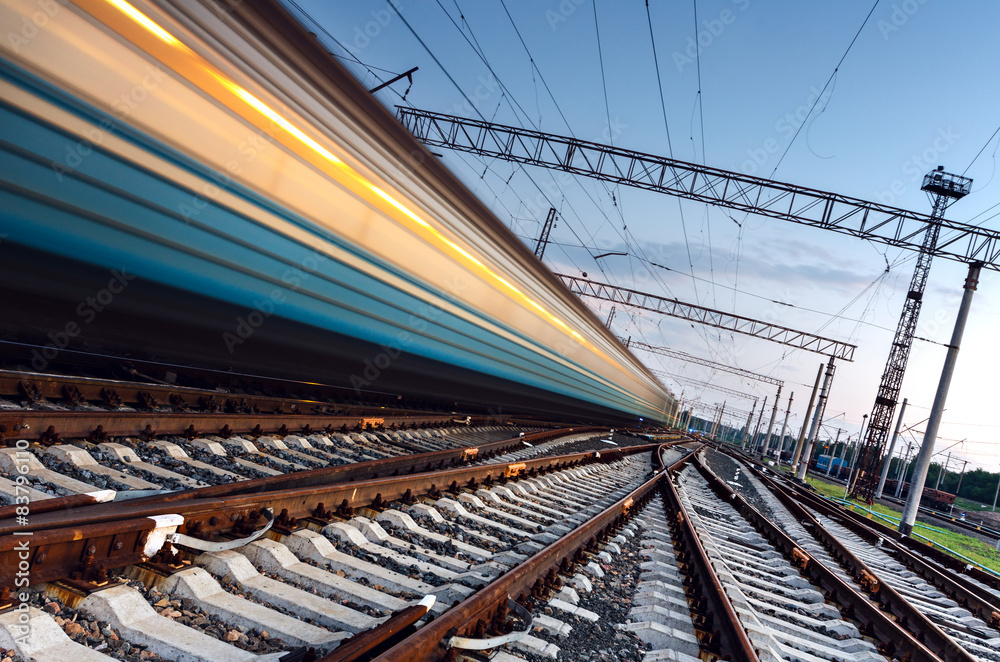 High speed passenger train on tracks with motion blur effect