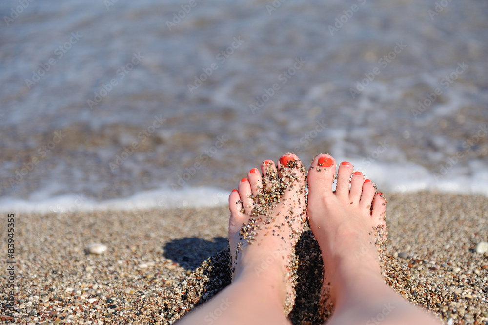 Woman feet closeup of girl relaxing on beach