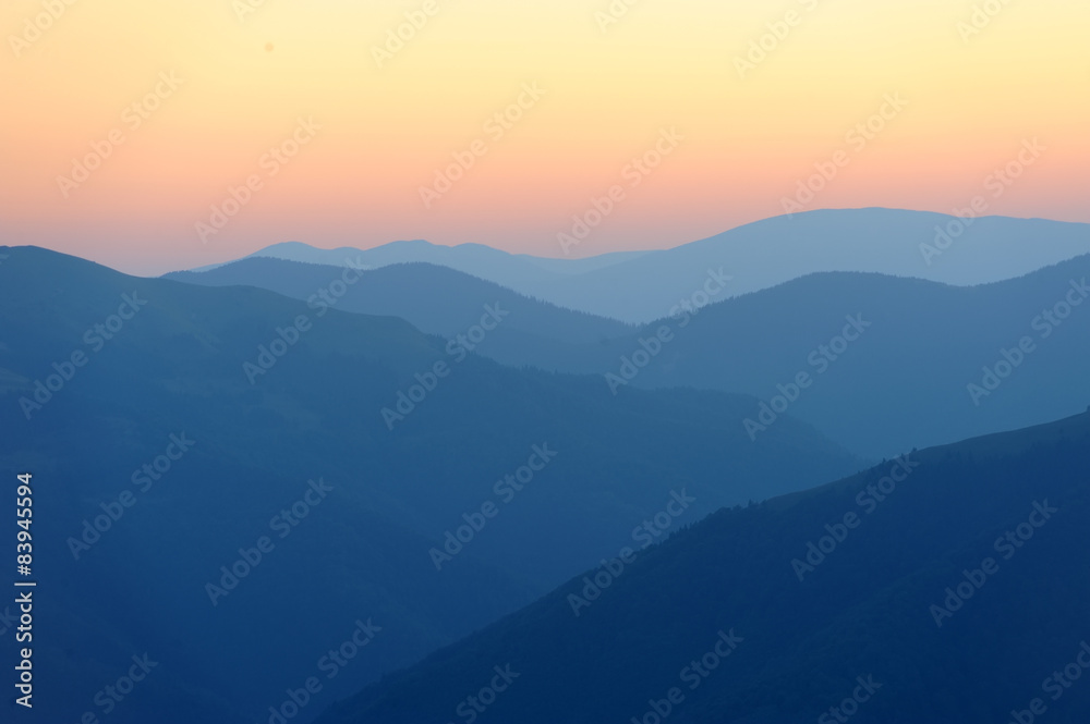 Sunrise over mountains silhouettes