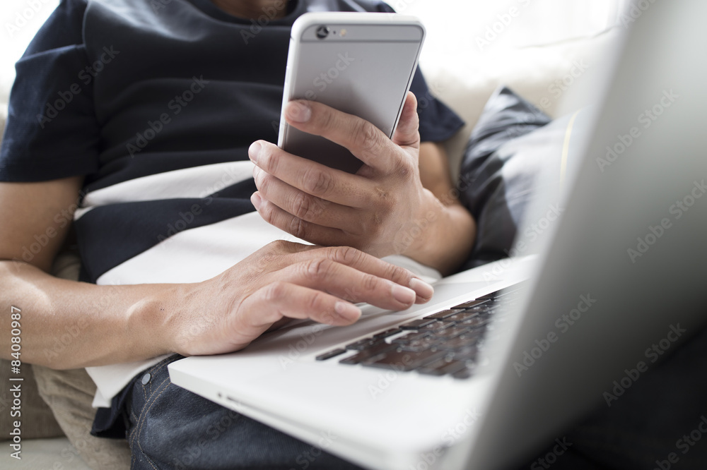 Men using a laptop and smartphone