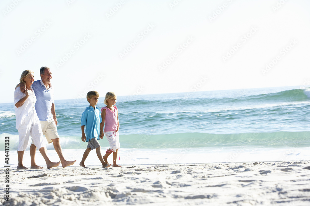 Grandparents and Grandchildren Walking Along Beach