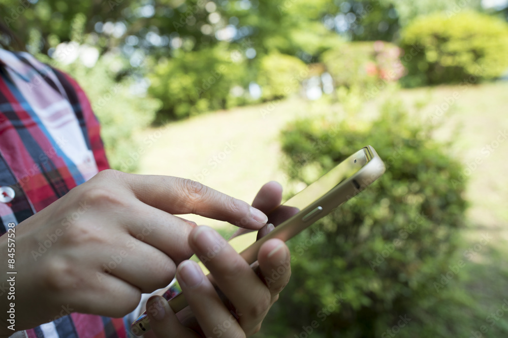 Women who have a smart phone in the park