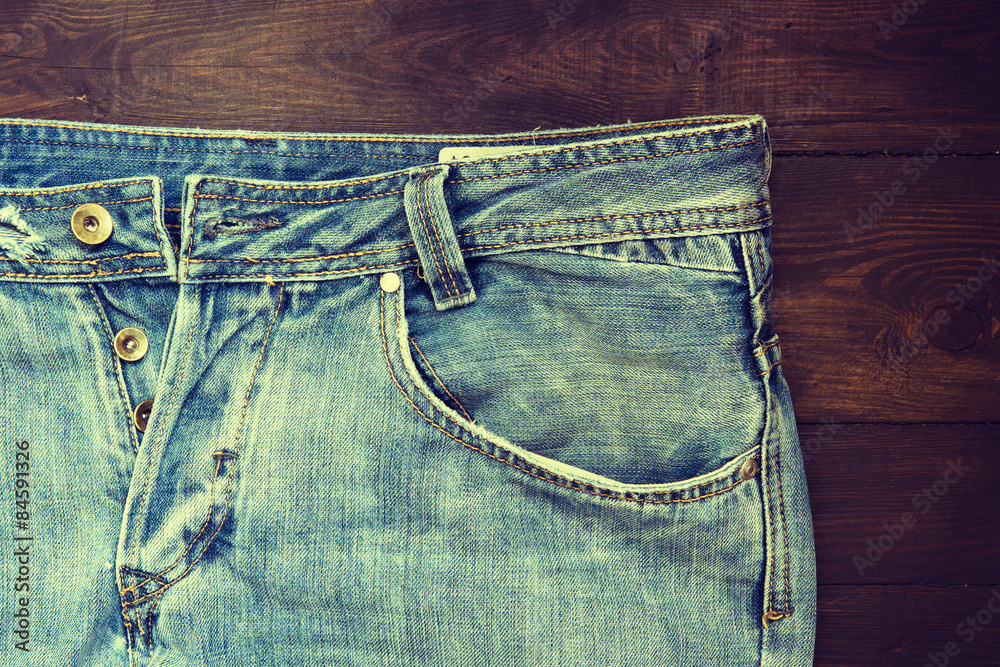 Blue Jeans on wooden background