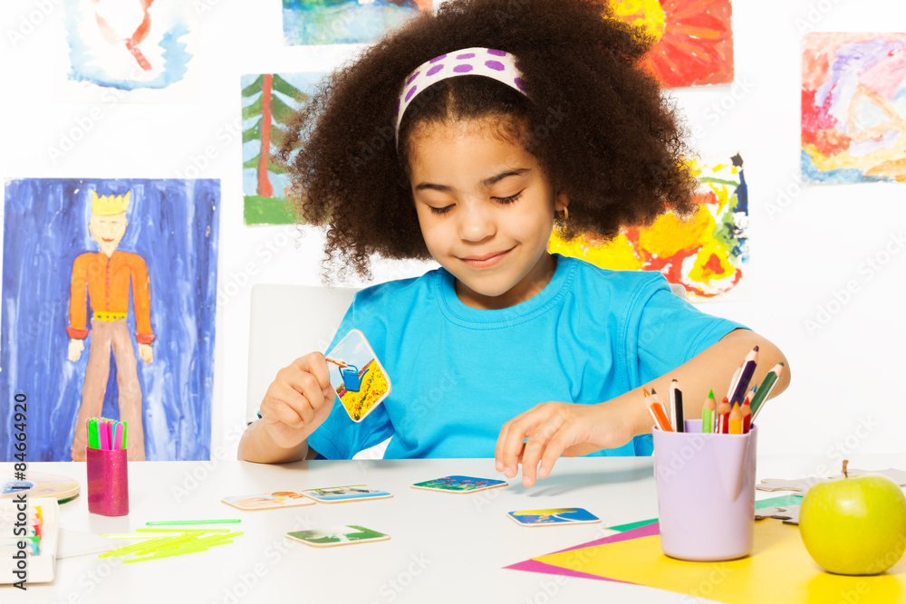 African girl match cards during developmental game