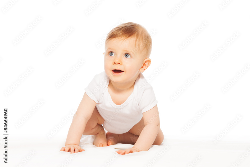 Looking amazed little baby on the white blanket