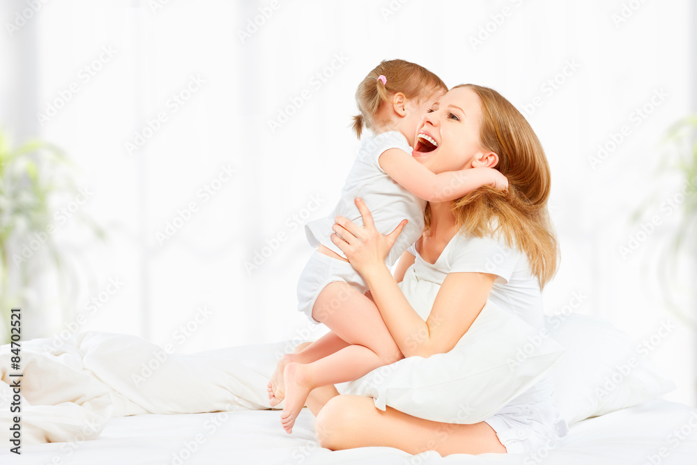 happy family mother and baby daughter playing and laughing baby