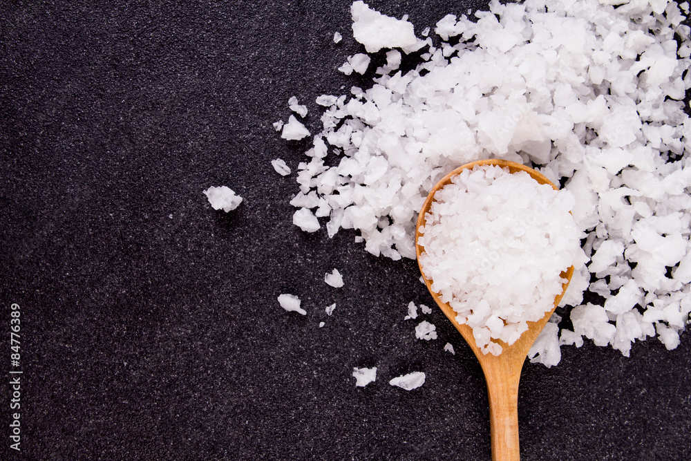 salt crystals on black stone plate background