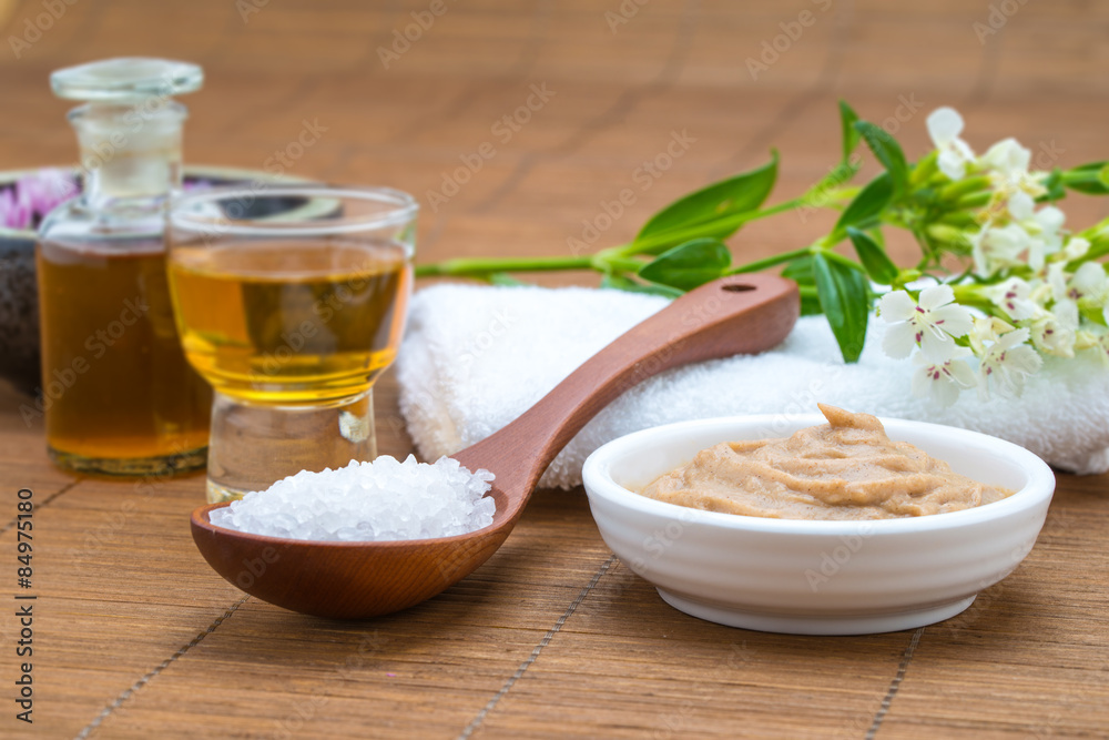 mask white bowl, essential oil,  salt spoon and towel, flower ba