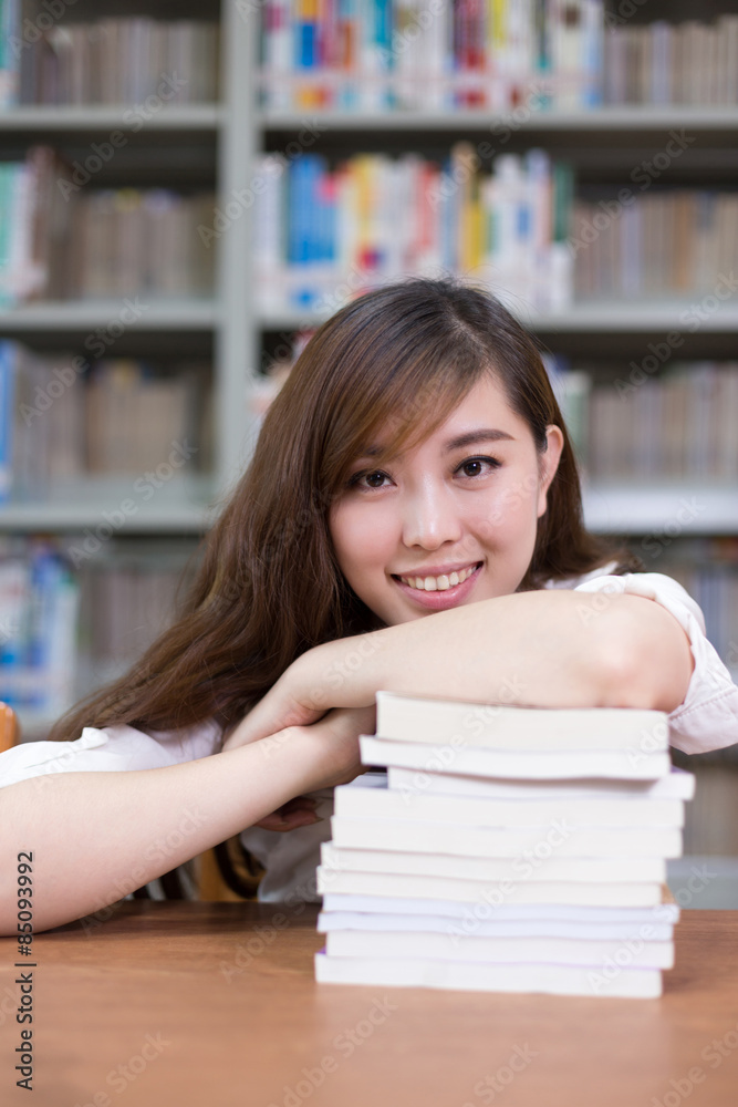 Beautiful asian female student portrait and books in library wit