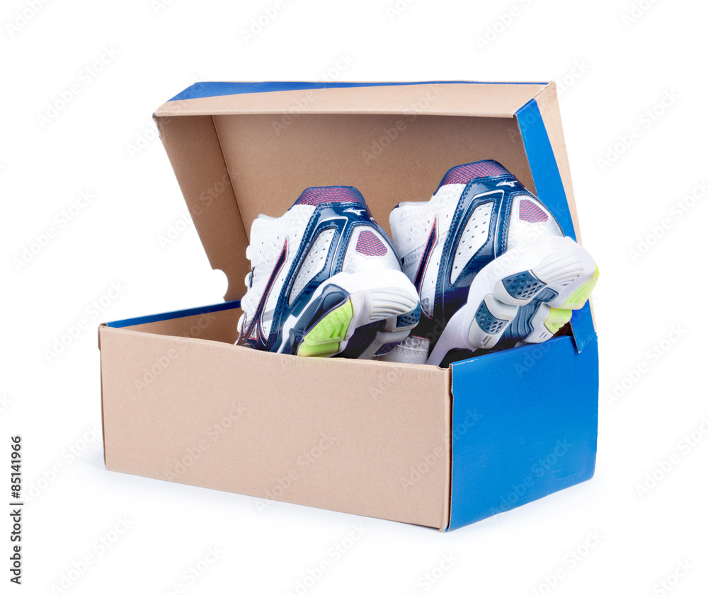 Pair of sneakers in shoe cardboard box isolated on white backgro