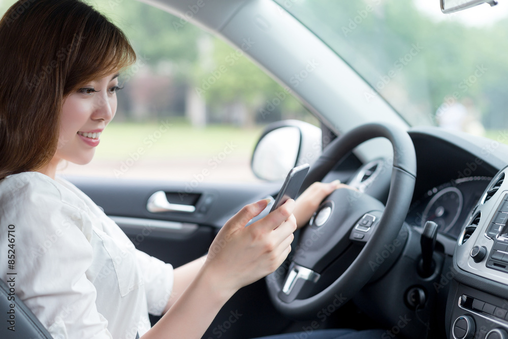 asian beautiful woman using mobile phone and driving car