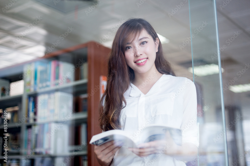 亚洲美女女学生在图书馆拿书