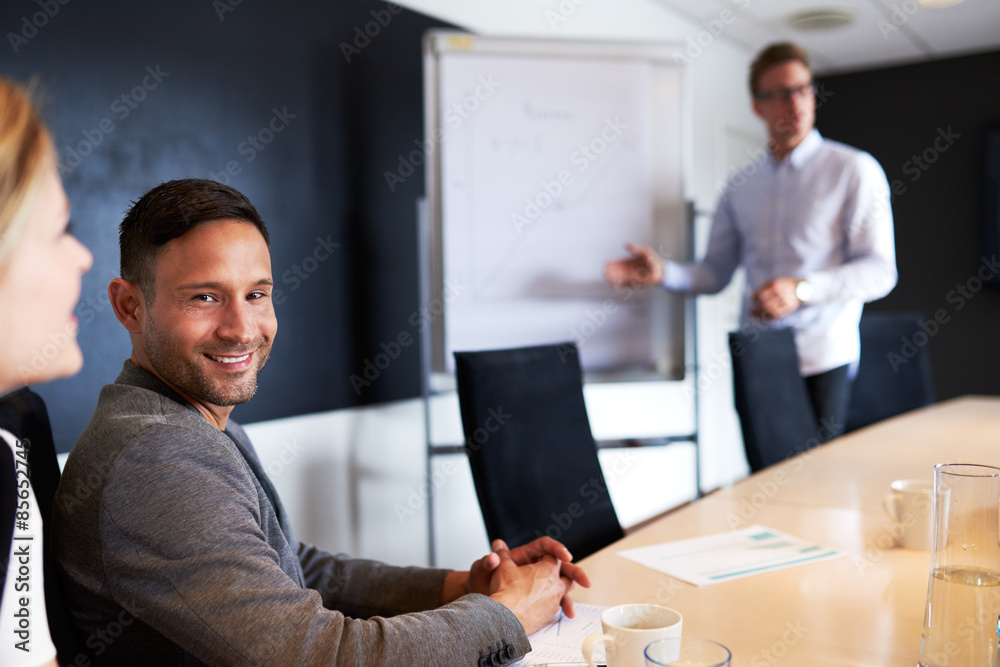 White male executive smiling and facing camera