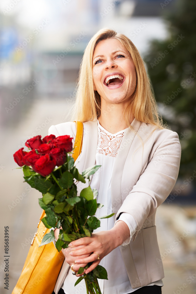 Woman with head tilted holding roses