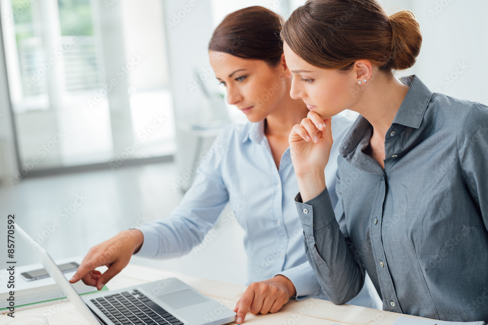 Business women working together on a laptop