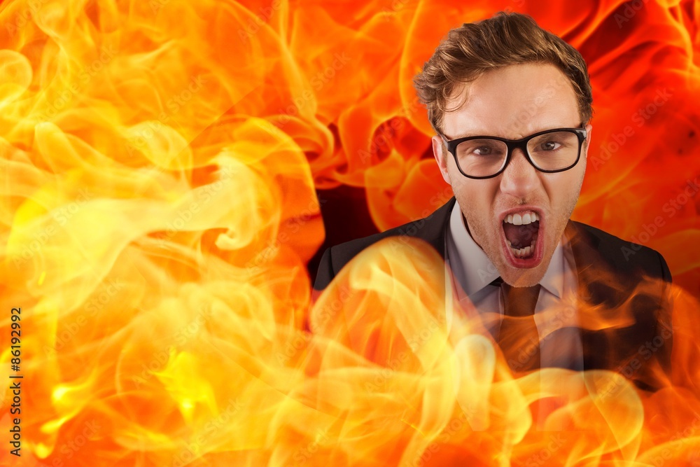 Composite image of young angry businessman shouting at camera