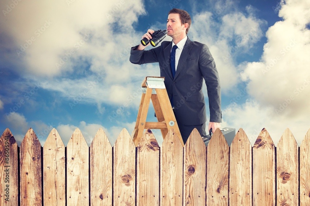 Composite image of businessman looking on a ladder