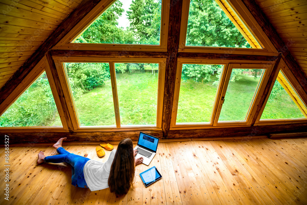 Woman working on the floor in wooden house