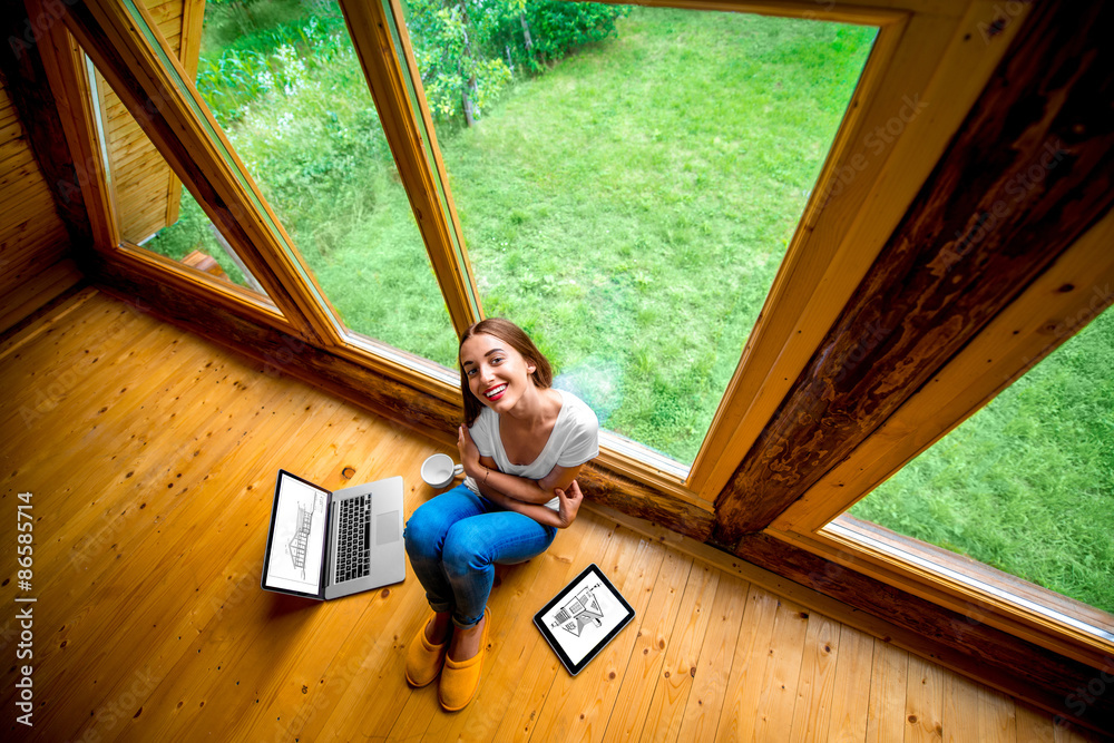 Woman sitting on the floor in wooden house