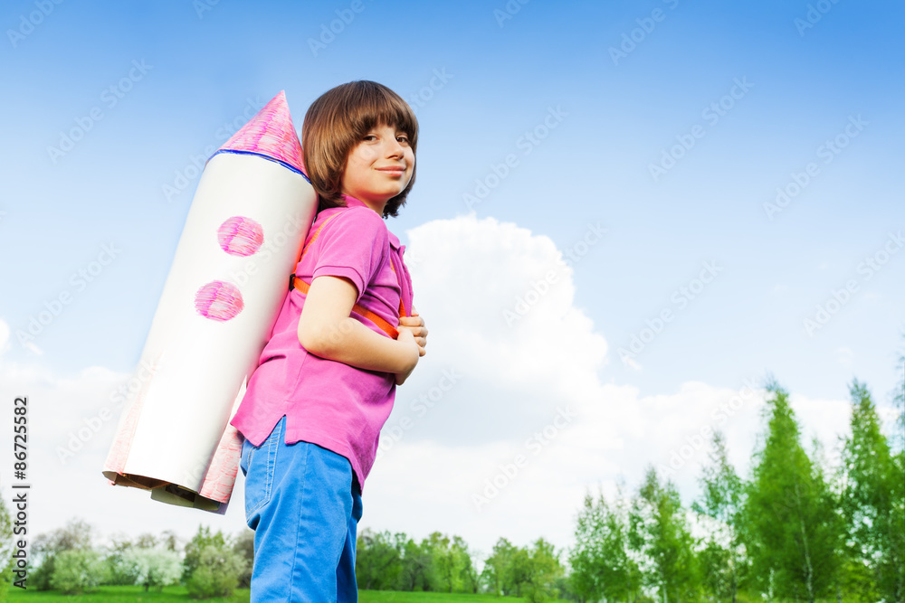 Smiling cute boy wearing carton rocket toy