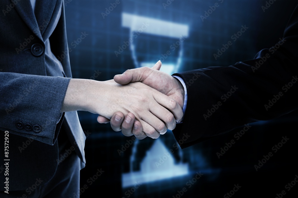 Composite image of close up of two businesspeople shaking their 