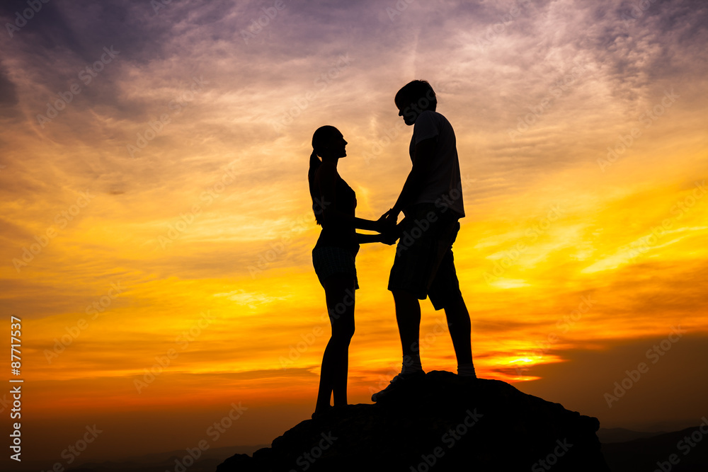 Silhouette of loving couple in sunset