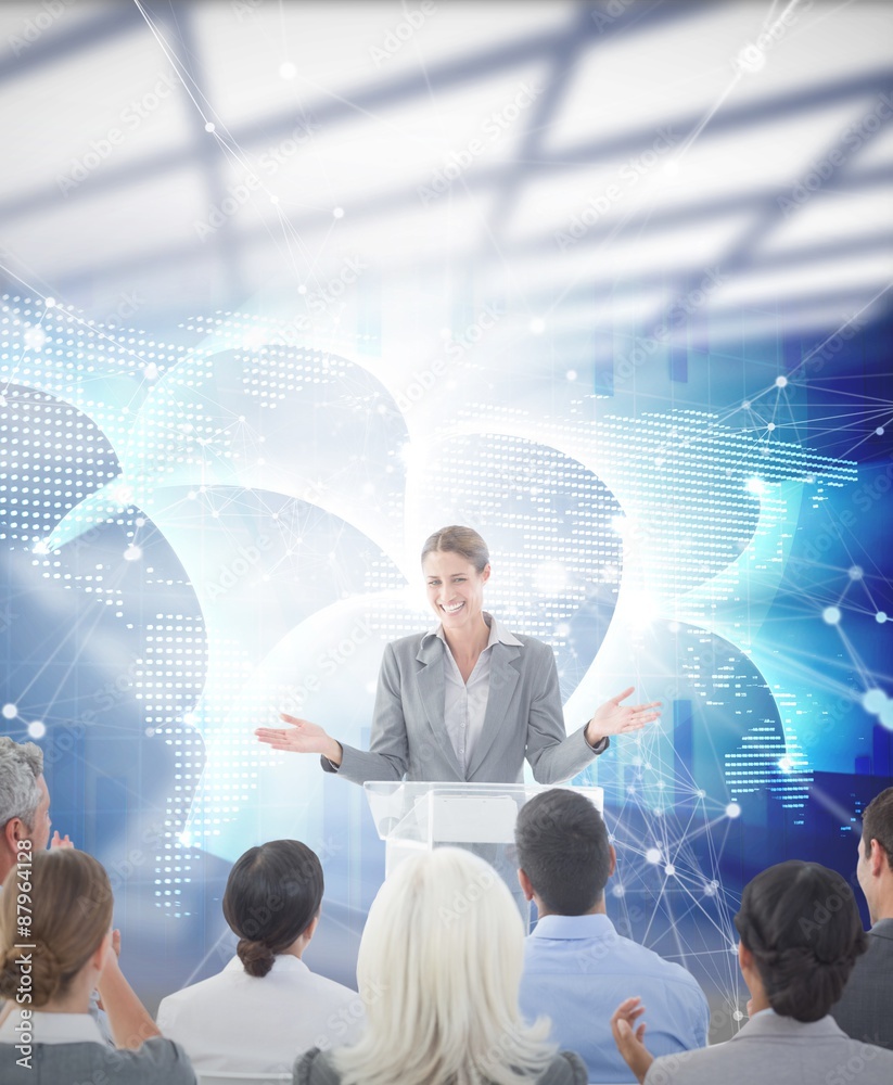 Composite image of businesswoman doing speech during meeting 