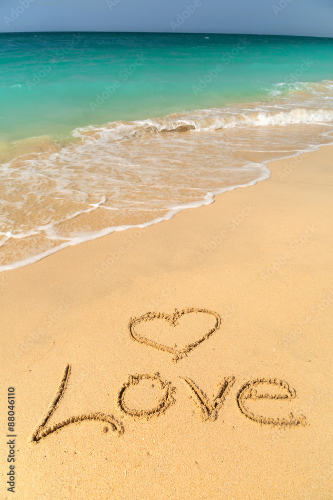 Love sign on the beach with turquoise water