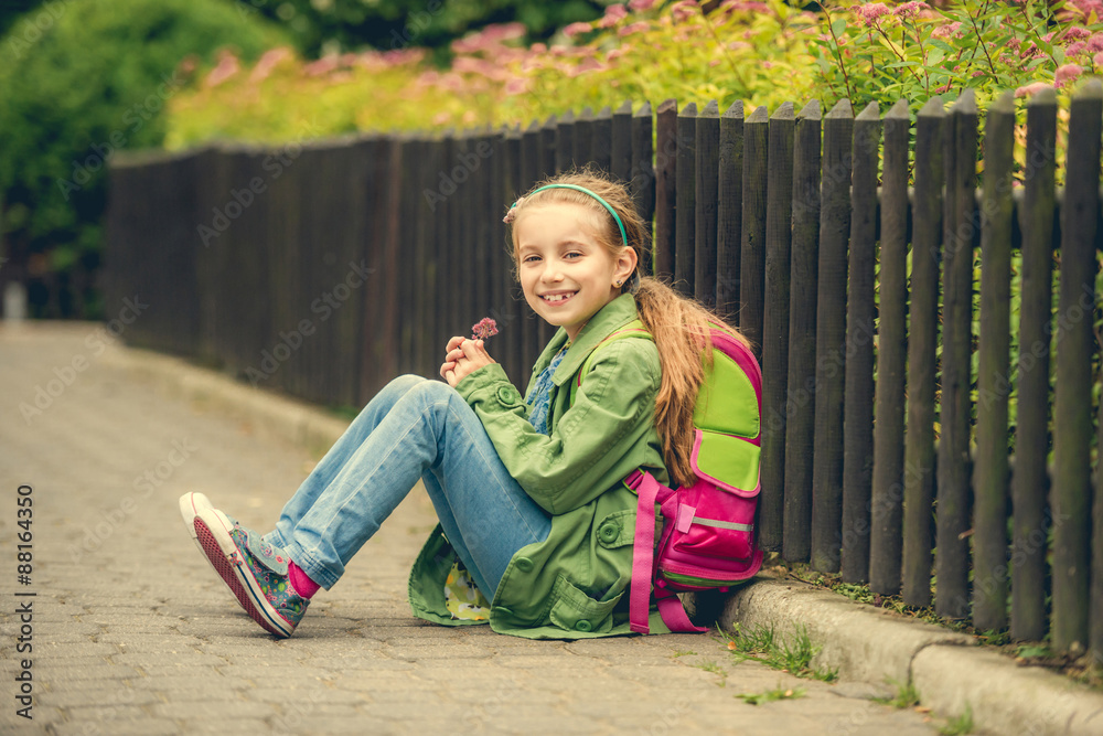  pretty schoolgirl  sitting on the street 