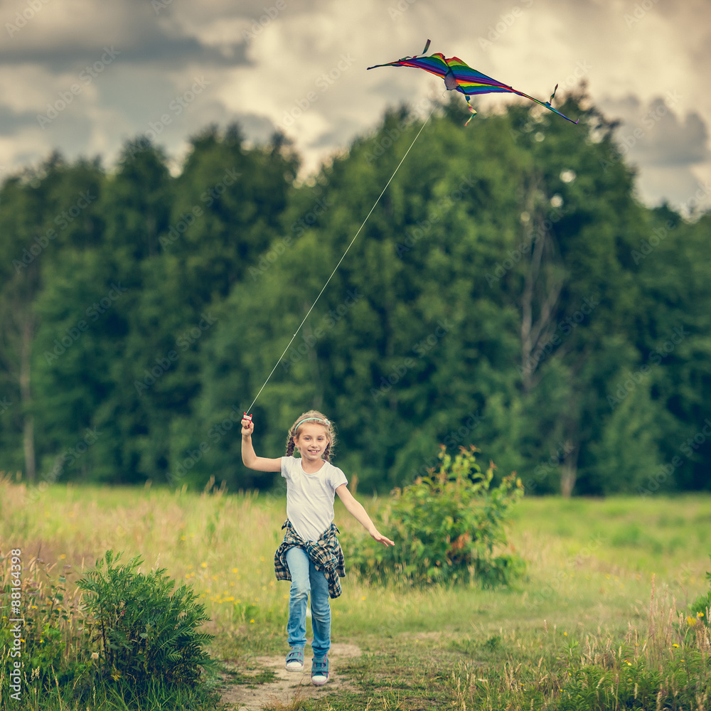 little cute girl flying a kite 