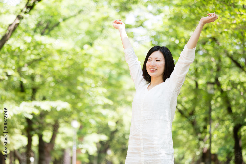 年轻的亚洲女人在公园里放松