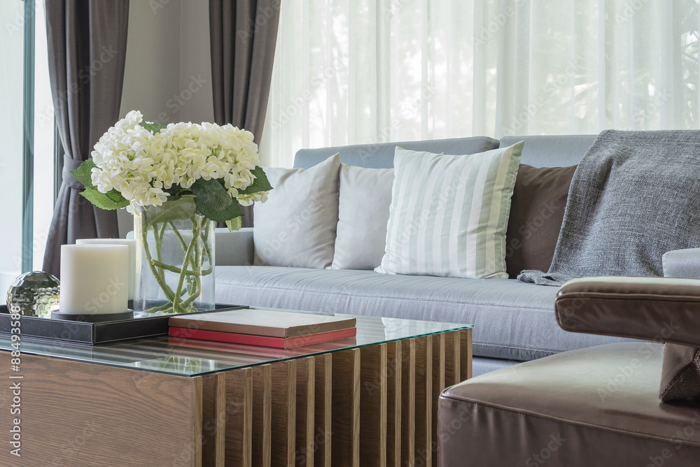 glass vase of plant on wooden table in living room