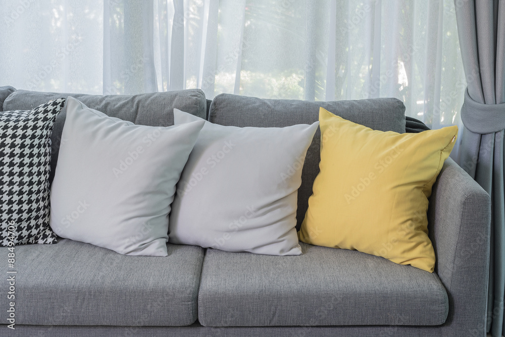 yellow pillow on grey sofa in modern living room