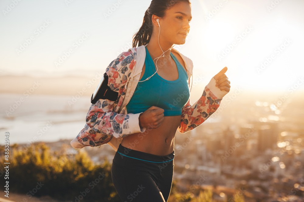 Confident young athlete running outdoors