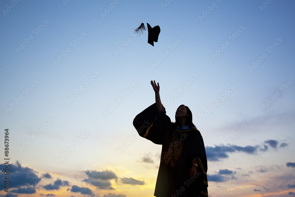 Silhouette Of Young Female Student Celebrating Graduation