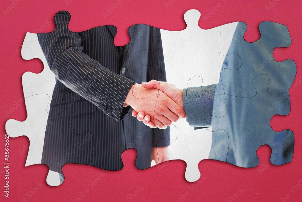 Composite image of business people shaking hands