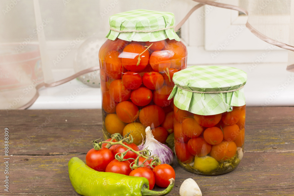 canned red cherry tomatoes in glass jars