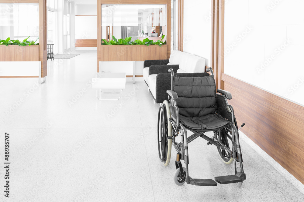 Empty wheelchair parked in hospital hallway