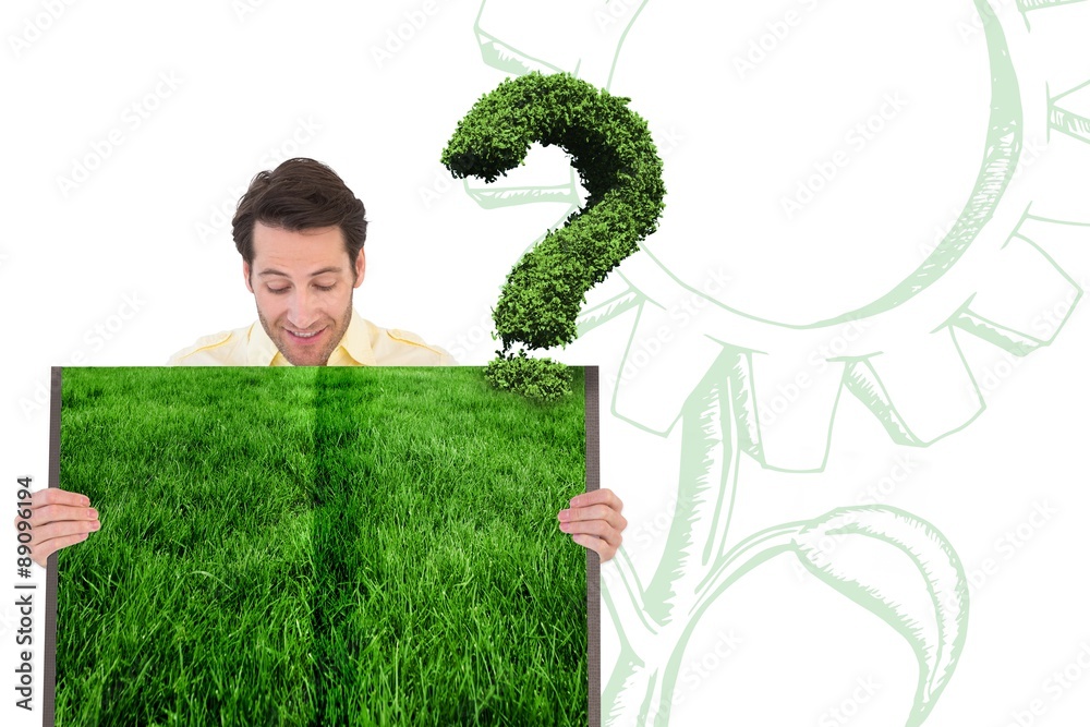 Composite image of man holding lawn book