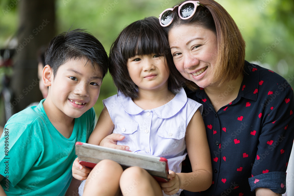 Asian family are playing together with a computer tablet in the