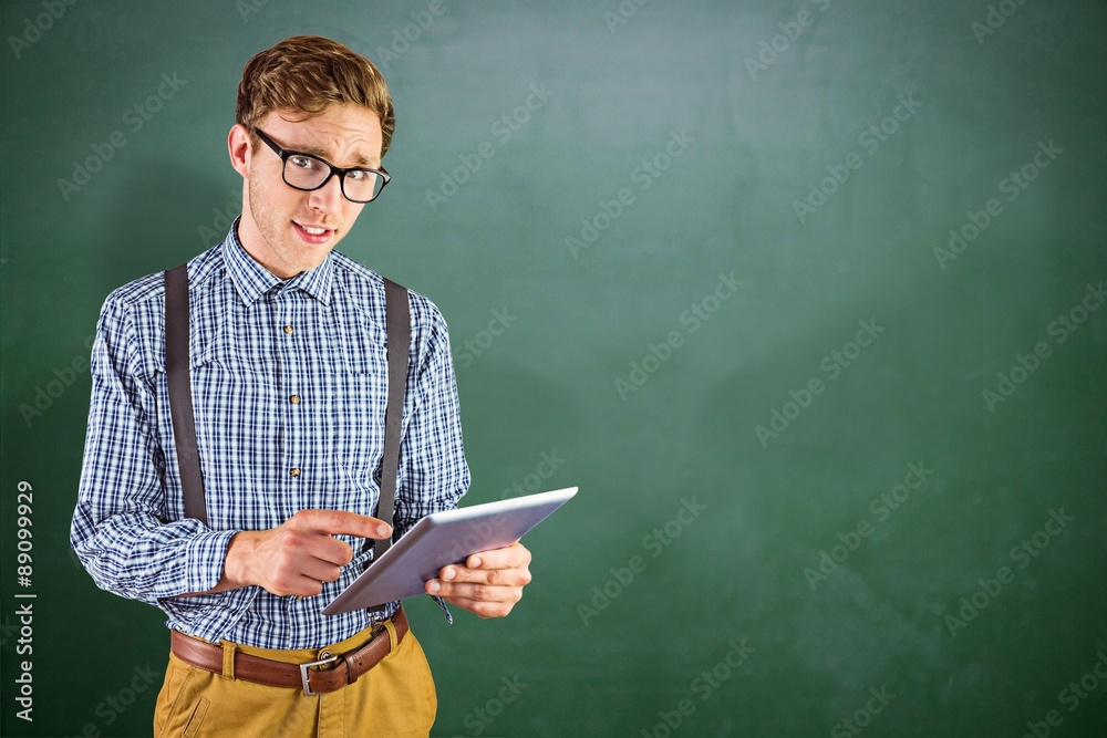 Composite image of geeky businessman using his tablet pc