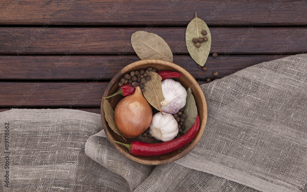 dish with spices on a wooden background. top view