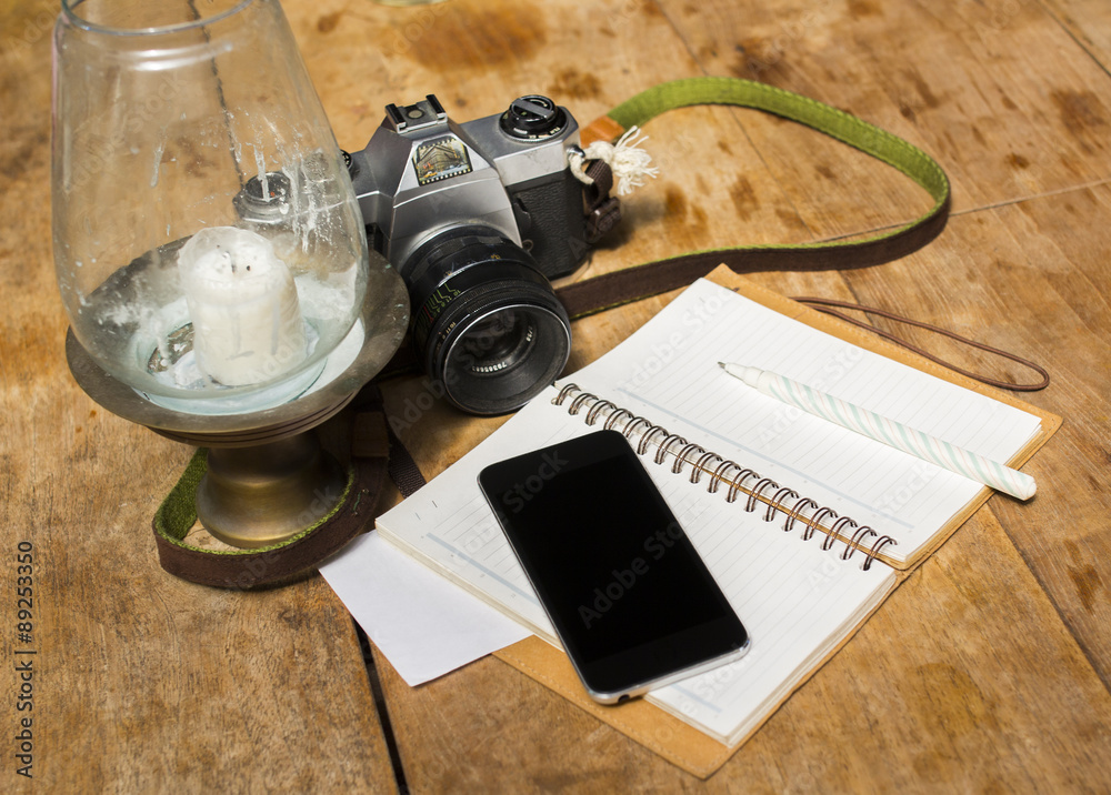 blank cell phone, diary and old photo camera