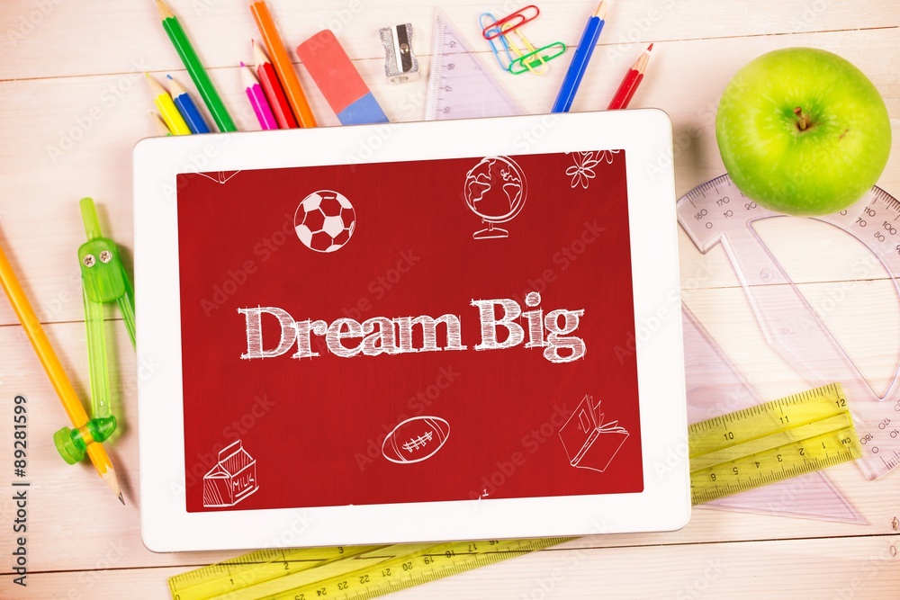 Dream big against students desk with tablet pc