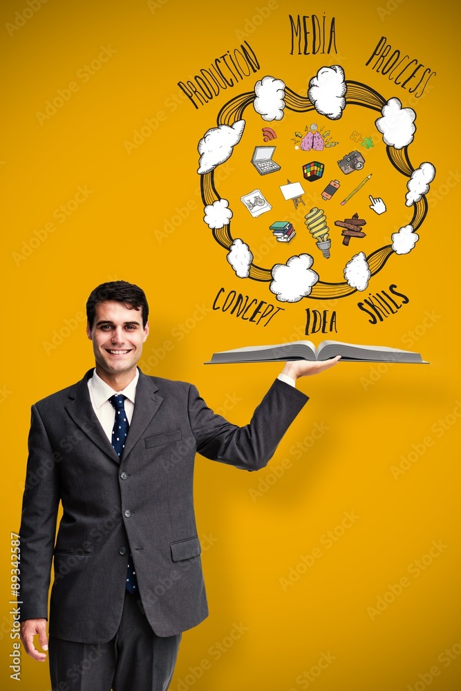 Composite image of businessman showing a book