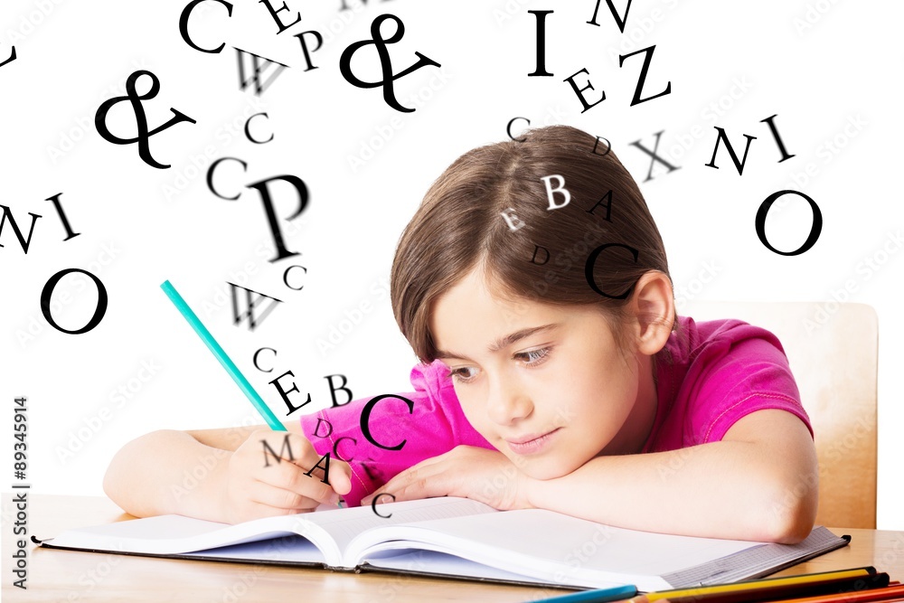 Composite image of cute pupil working at her desk