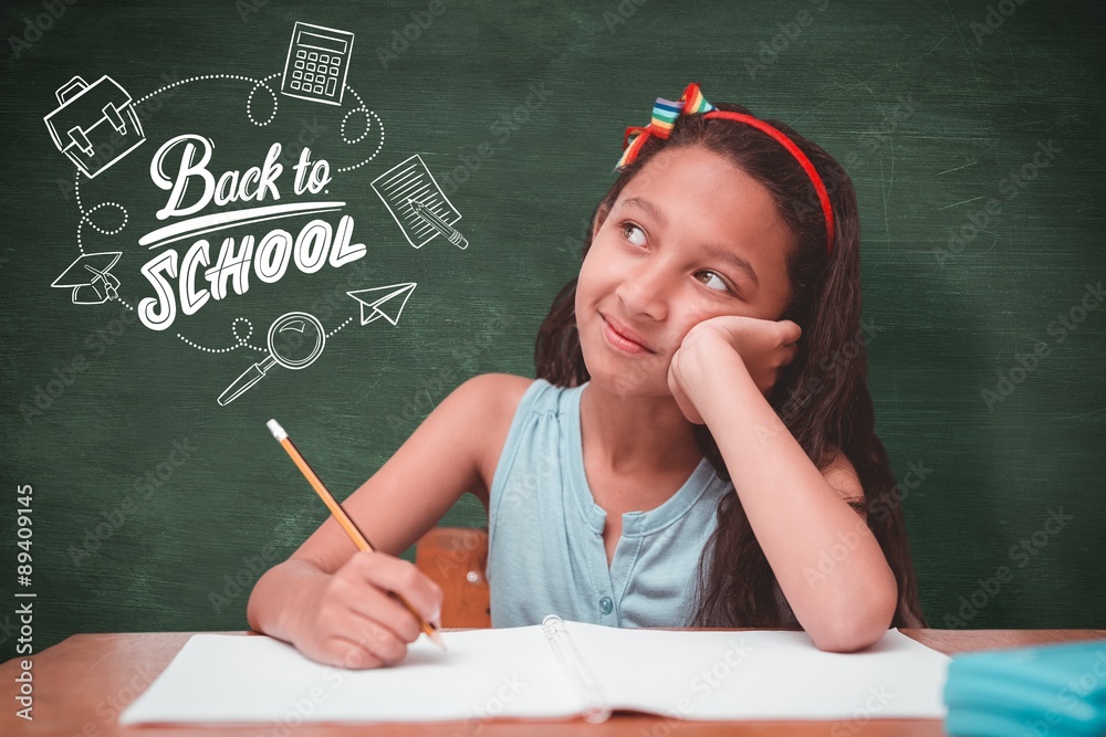 Composite image of cute pupil at desk